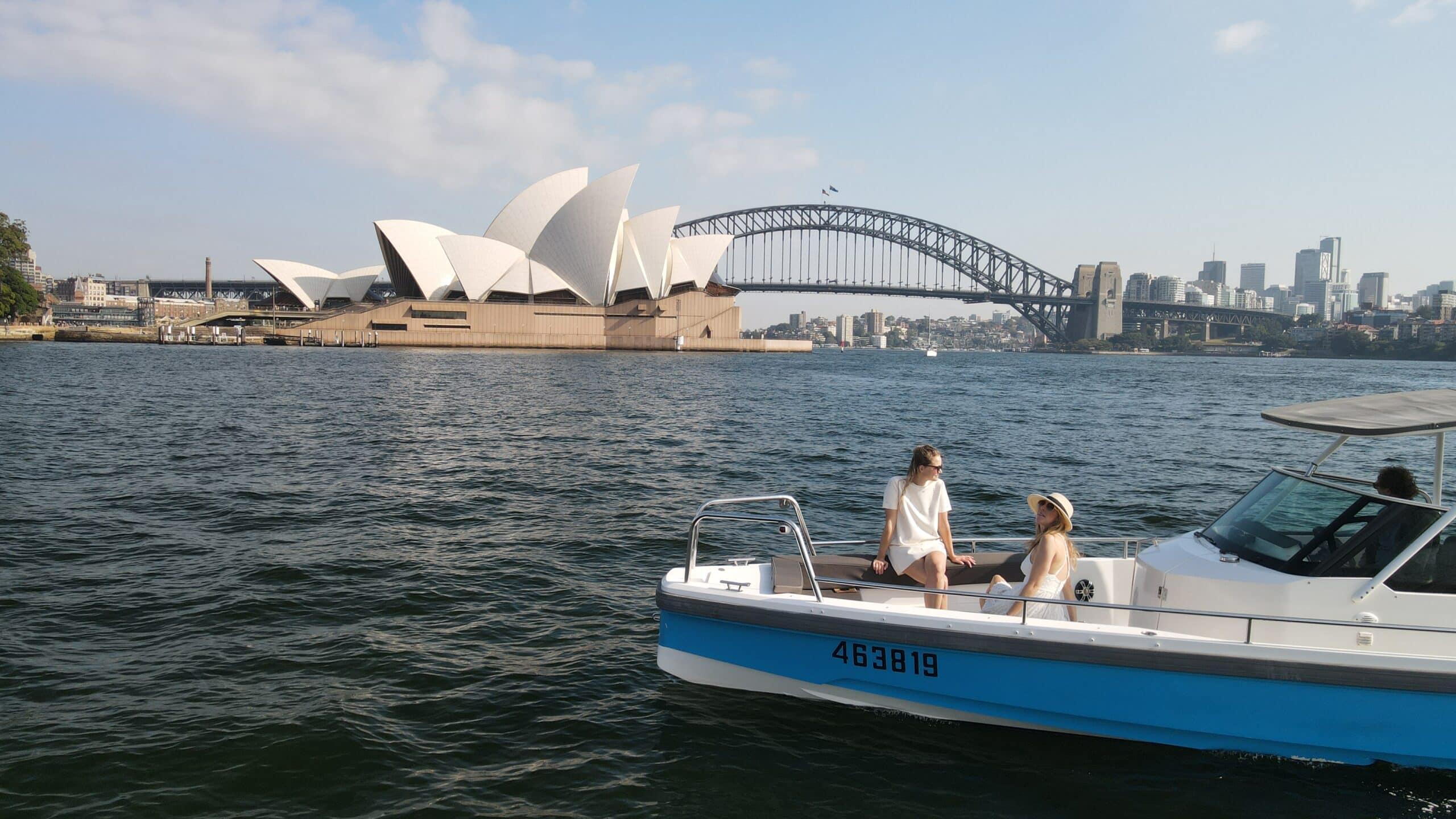 The Coral small self-drive boat on Sydney Harbour with the Opera House and Harbour Bridge behind, no licence required