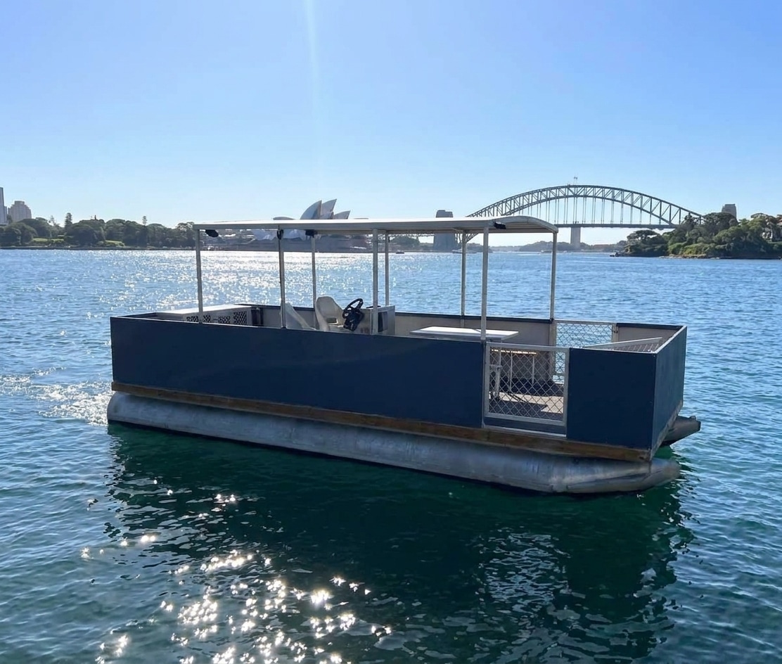 A pontoon boat on Sydney Harbour available for self-drive hire without a licence